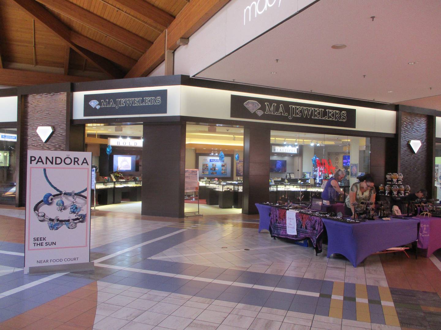 Crafters selling their wares at the Louis Joliet Mall set up tables Sunday morning. Joliet. July 9, 2023.