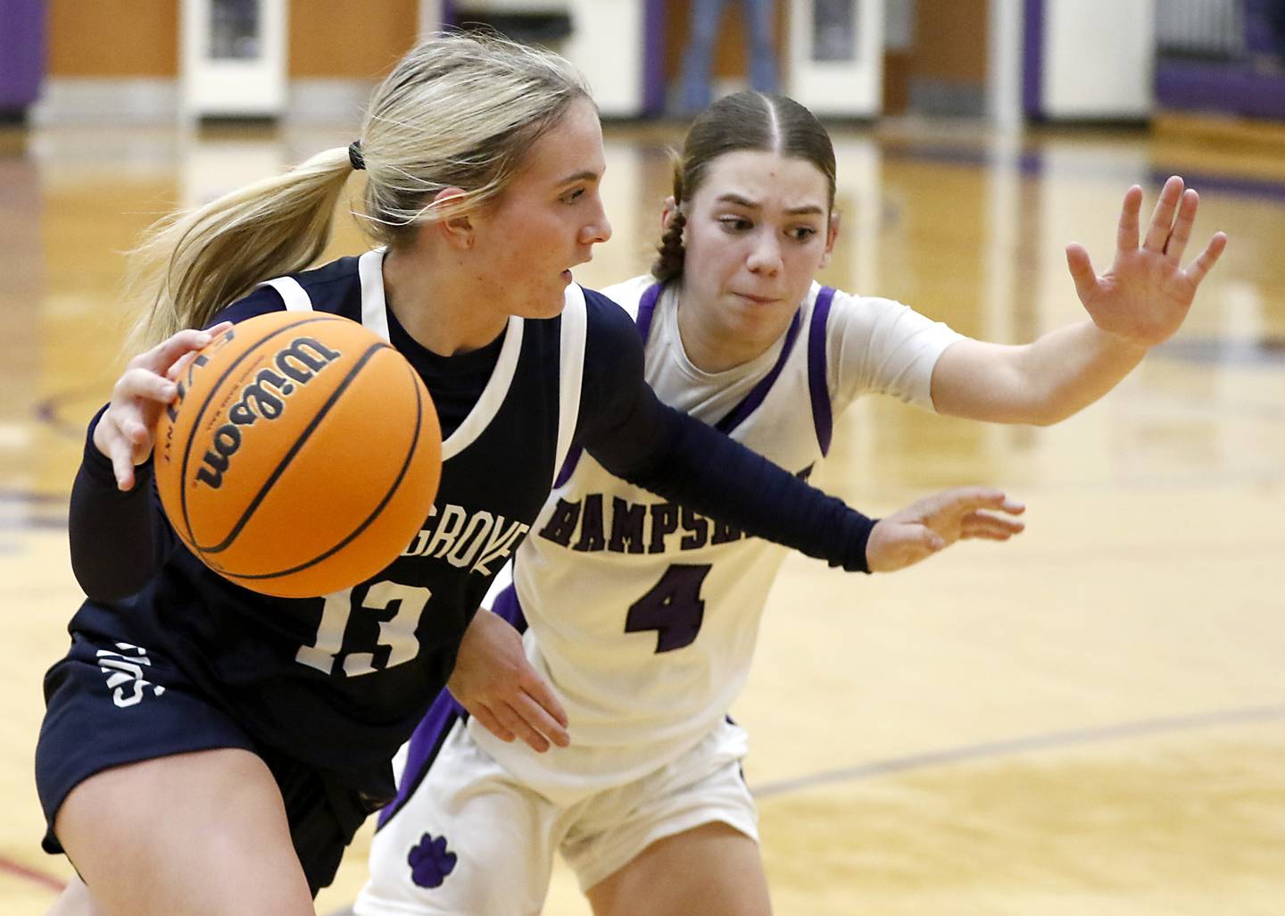 Cary-Grove's Malaina Kurth drives to the basket against Hampshire's Peyton McCarthy during a Fox Valley Conference girls basketball game on Monday, Dec. 9, 2024, at Hampshire High School.