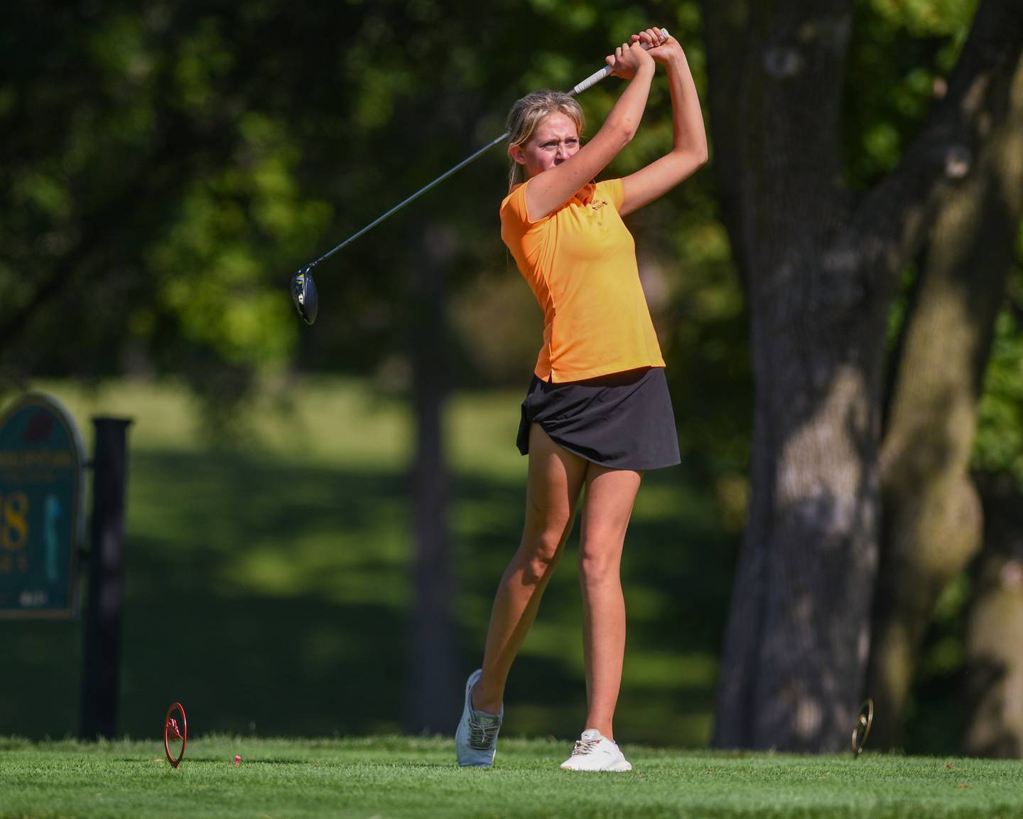 Emily Geurts of St. Charles East watches her ball after teeing off during the DuKane conference meet on Tuesday Sept. 23, 2025, held at Phillips golf course in Aurora.