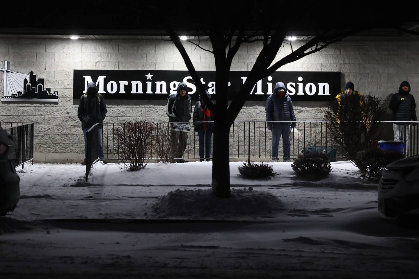 People line up outside MorningStar Mission shelter in Joliet as temperatures are expected to fall below zero degrees.