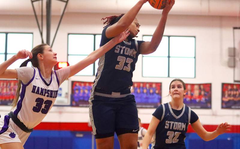 Hampshire’s Jesslyn Mack, left, and South Elgin’s Liv Miller battle for a rebound in varsity girls basketball Komaromy Classic tournament  action on Monday, Dec. 29, 2025, at Dundee-Crown High School in Carpentersville.