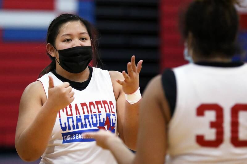 Gianine Boado, left, and Alyssa Crenshaw, right, discuss positioning as they drill during girls basketball practice at Dundee-Crown High School on Tuesday, Feb. 2, 2021in Carpentersville.