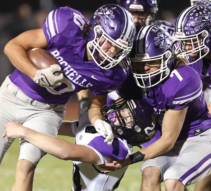 Dixon’s Hunter Vacek tries to bring down Rochelle's Garrett Gensler during their first round playoff game Friday, Oct. 28, 2022, at Rochelle High School.