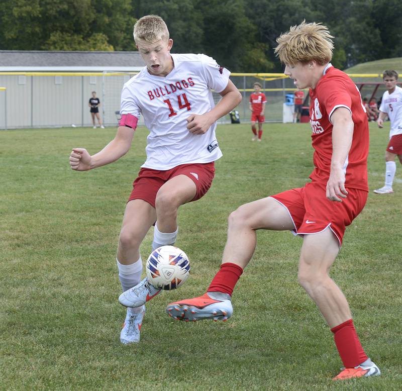 Streator’s Joe Hoekstra works to block a shot by Ottawa’s Robert Poliier in the 1st half of Saturday’s match at Ottawa.