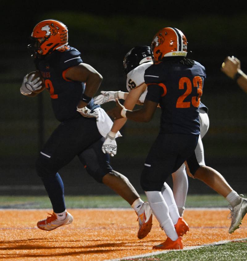 Naperville North's Donavan Howard scores a touchdown after picking up a Neuqua Valley fumble during a football game played on Friday, Oct. 11, 2024 in Naperville.
