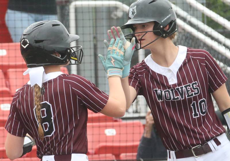 Prairie Ridge's Adysen Kiddy hi-fives Kylie Carroll after scoring a run against Burbank during the Class 3A State third place game on Saturday, June 14, 2025 at the Louisville Slugger Sports Complex in Peoria.