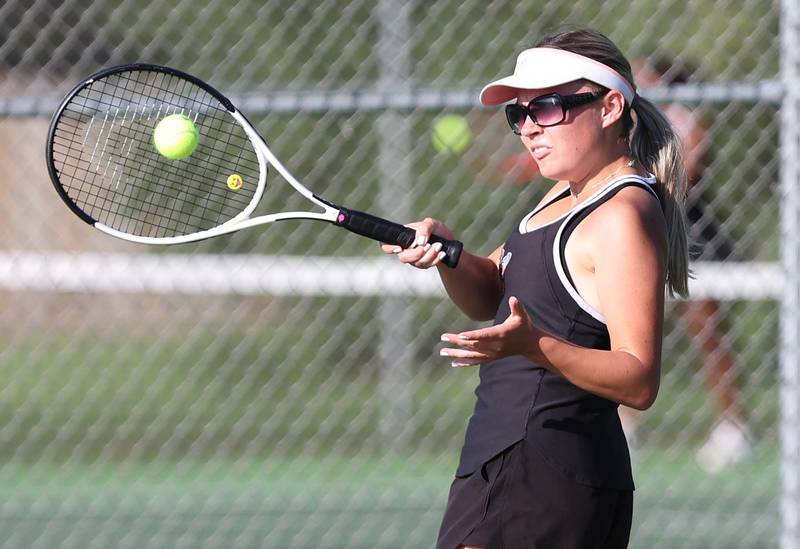 DeKalb's Nina Christopherson hits a forehand during her match against Sycamore's Jordyn Tilstra Monday, September 19, 2022, at Sycamore High School.