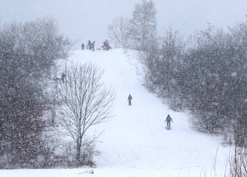 Kids sled down the hill at Coal Minors Park on Tuesday, Jan. 9, 2024 in Spring Valley.
