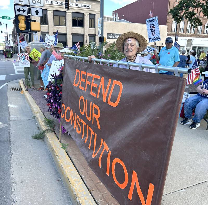 A man stands beind the sign he made and displays it at the "Workers Over Billionaires" rally in downtown Oregon on Monday, Sept. 1, 2025. The two-hour rally was held on two of the sidewalks surrounding the historic Ogle County Courthouse.