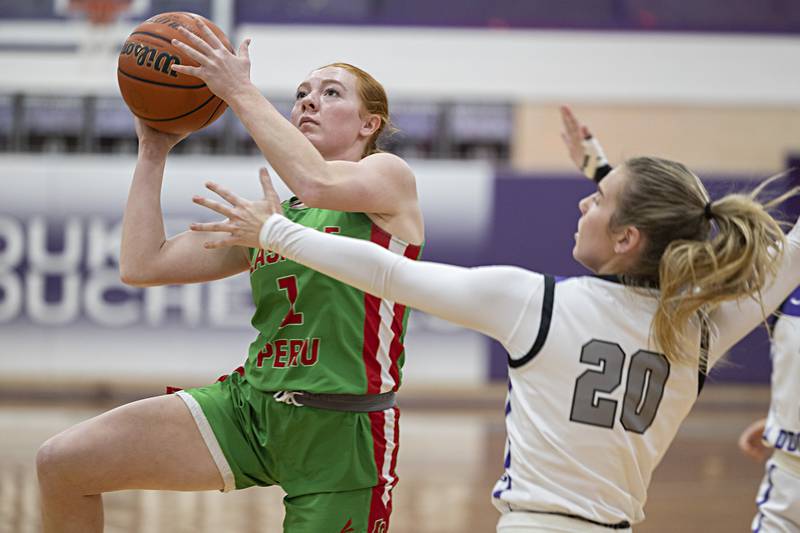LaSalle-Peru’s Addison Duttlinger drives the lane to put up a shot against Dixon’s Nora Fordham Thursday, Nov. 30, 2023 in Dixon.