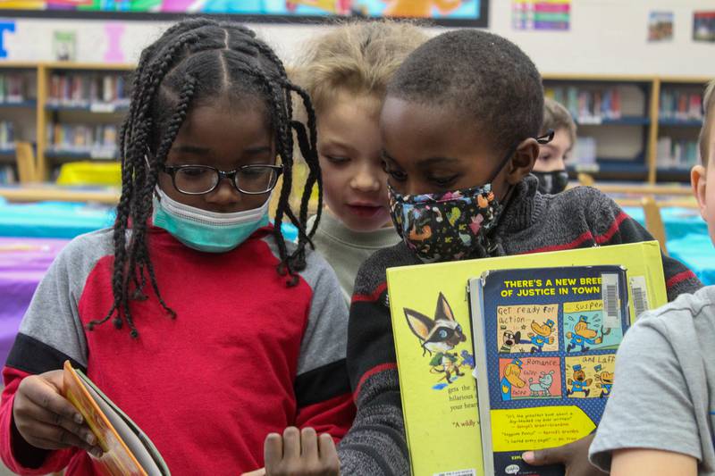 Kindergartners at Thomas Jefferson Elementary School in Plainfield return to Kimberly Jurani's class with a newly checked-out book from the media center on Thursday, March 3, 2022, after exploring different book genres to celebrate Read Across America week. Even though kids often didn't experience mild illness with COVID, they had disruptions to their routines, school life, social life, and the uncertainty of ever-changing mitigations.