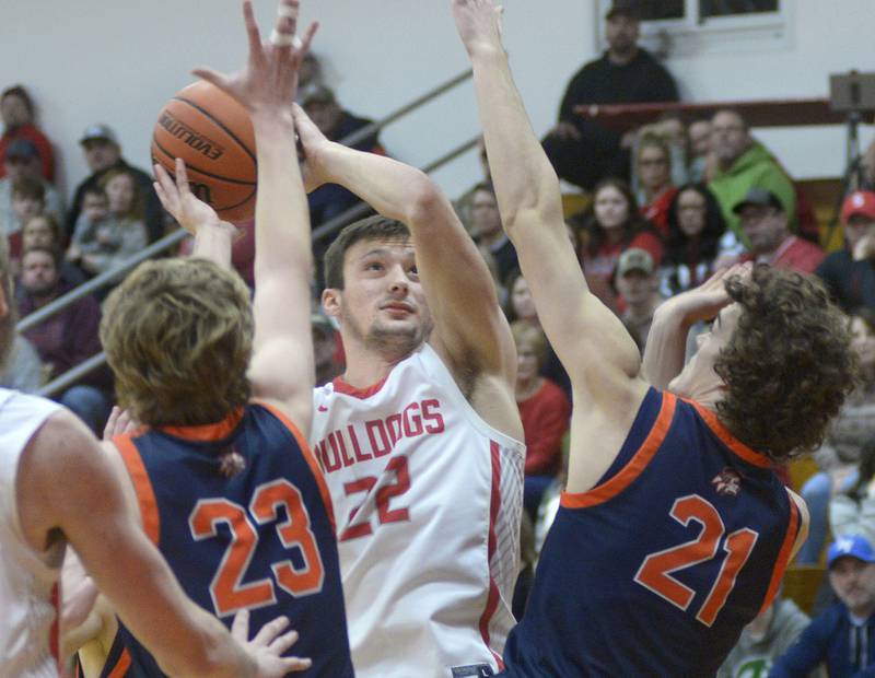 Streator’s Christian Benning works to shoot between the blocks of Pontiac’s Conrad Pfaff and Riley Weber in the 2nd period Saturday at Streator.