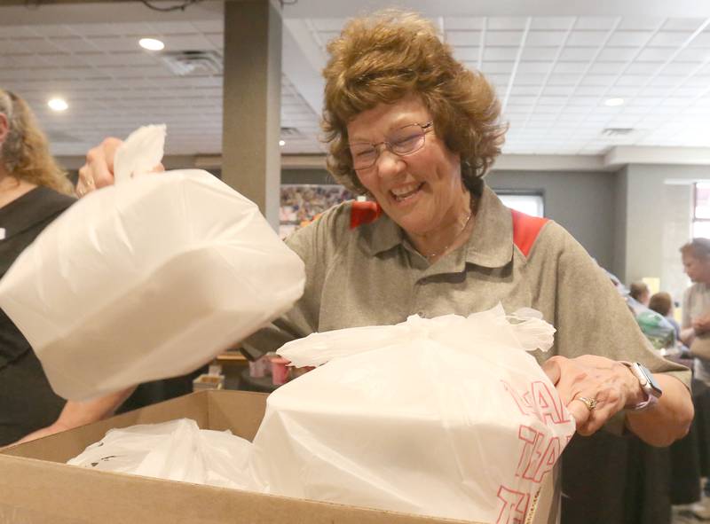 Jessica Kreiser executive director at Lighted Way, packs to-go containers during the Lighted Way spaghetti dinner on Monday, April 28, 2025 at Uptown Bar & Grill downtown La Salle.