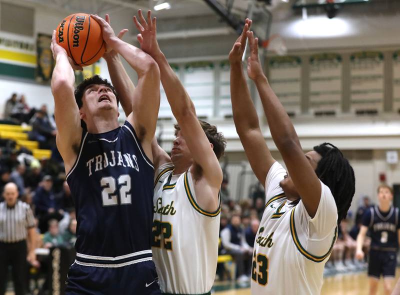 Cary-Grove's Adam Bauer (left) shoots the ball in front of Crystal Lake South's Nick Stowasser (center) and David Mcfadden (right) during a Fox Valley Conference boys basketball game on Friday, Jan. 23, 2026, at Crystal Lake South High School.