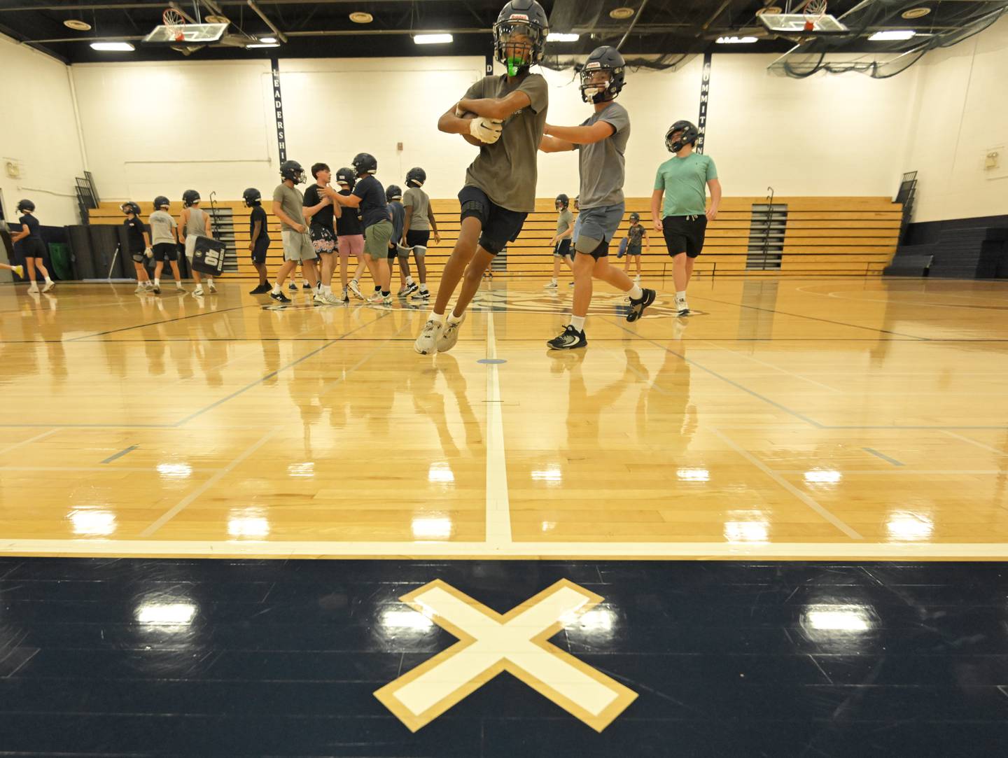 Lisle High School football practice in the school gymnasium on Tuesday, August 12, 2025.