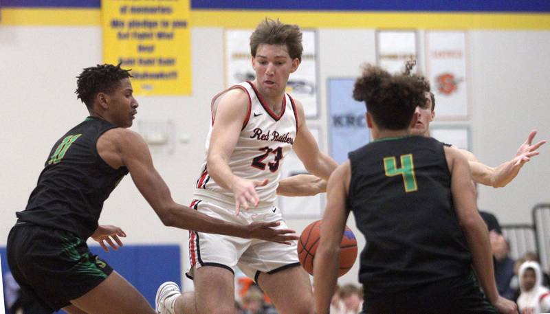 Huntley’s Ethan Blackmore, center, moves the ball against Crystal Lake South’s Christian Rohde, left, in varsity basketball tournament title game action at Johnsburg Friday.