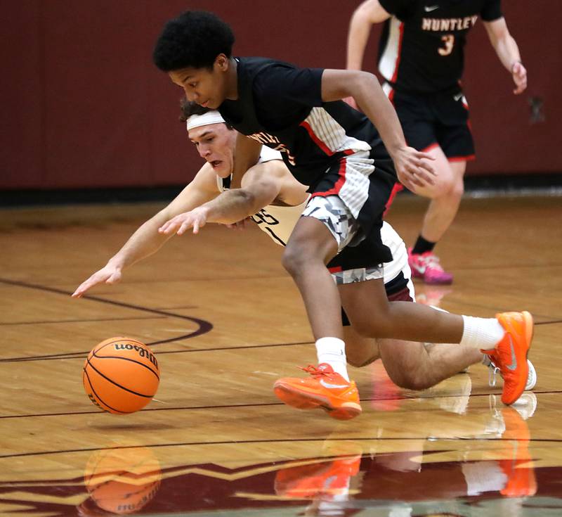 Prairie Ridge's Luke Vanderwiel and Huntley's Isaac Muze go after a loose ball during a Fox Valley Conference boys basketball game on Wednesday, Jan. 21, 2026, at Prairie Ridge High School in Crystal Lake.