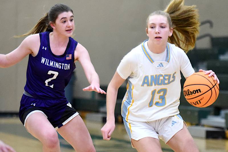 Joliet Catholic Academy's Abigail Dulinsky, right, drives past Wilmington's Sami Liaromatis during and IHSA Class 2A Coal City Regional semifinal Tuesday, Feb. 18, 2025.