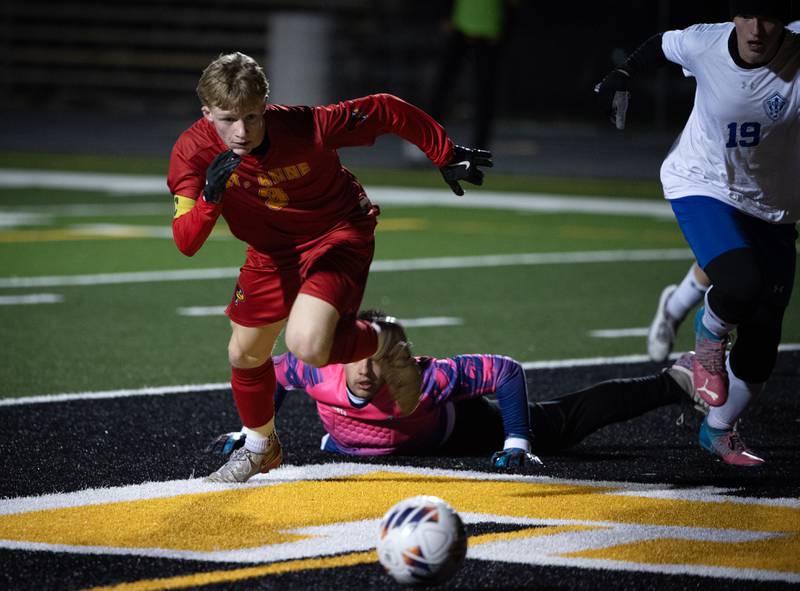 St. Anne's Brigham Hays, left, and Clifton Central's Logan Kuipers, right, scramble after a loose ball in the box after a block by Clifton Central during a regional match-up on Tuesday, October 21, 2025.