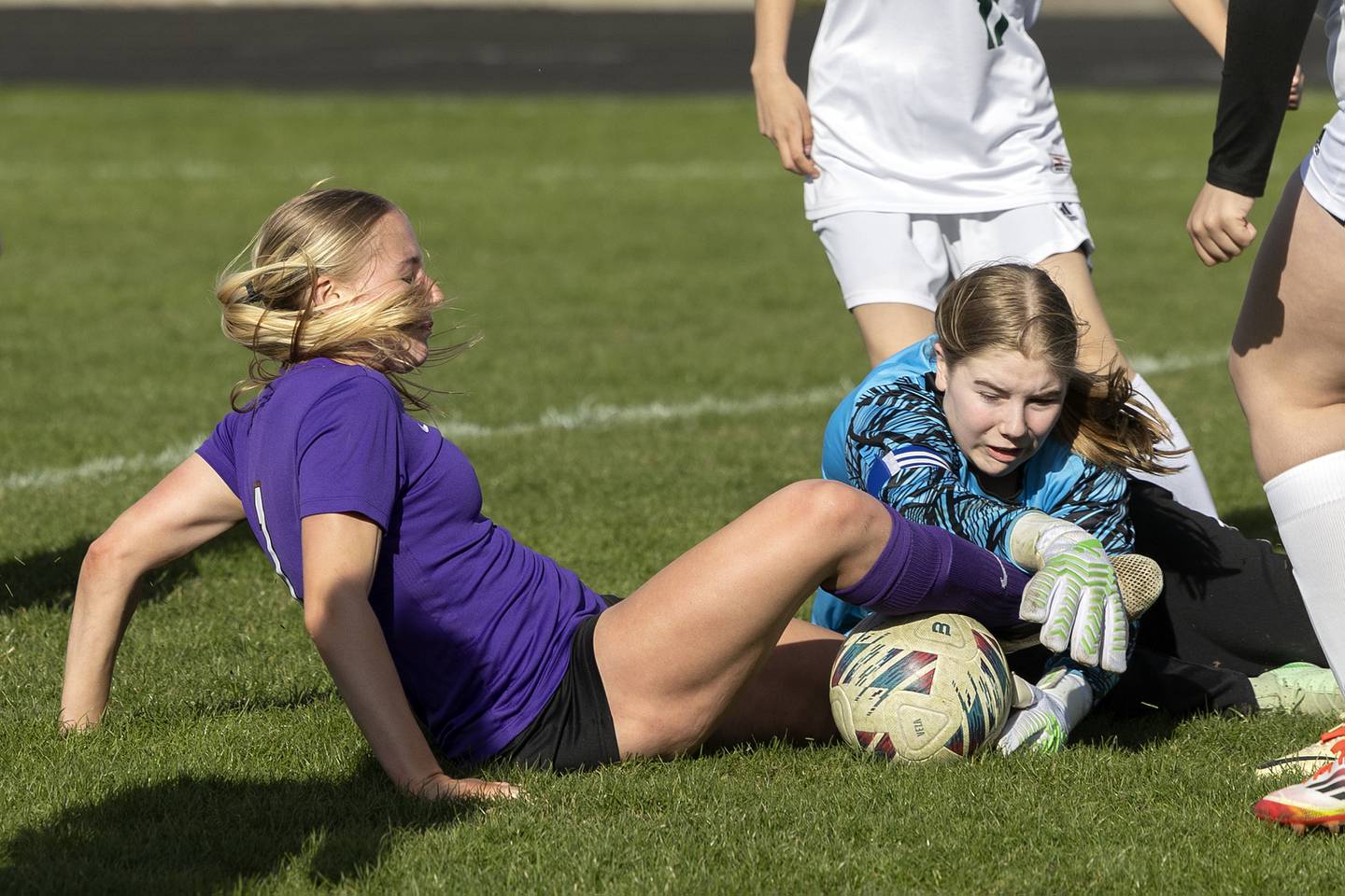 Dixon’s Micki Worrell battles the North Boone goalie for the ball Tuesday, April 15, 2025.