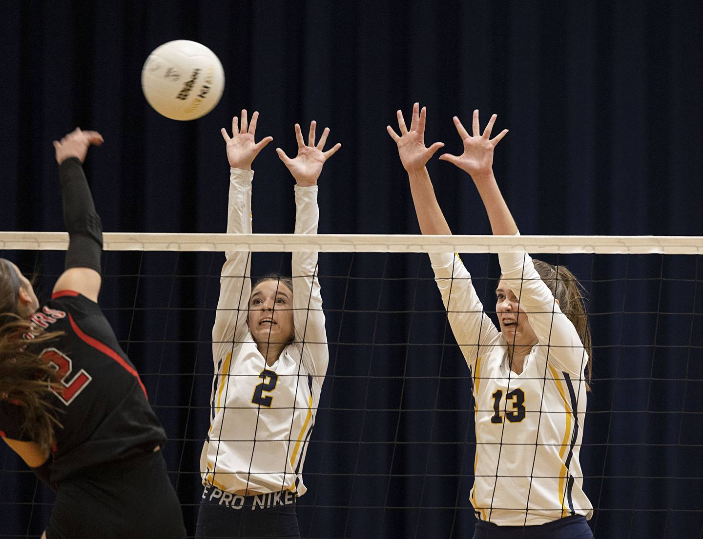 Polo’s Ellie Wells (left) and Lindee Poper go up for a block in game one of their semifinal regional match Wednesday, Oct. 26, 2022 against Fulton.