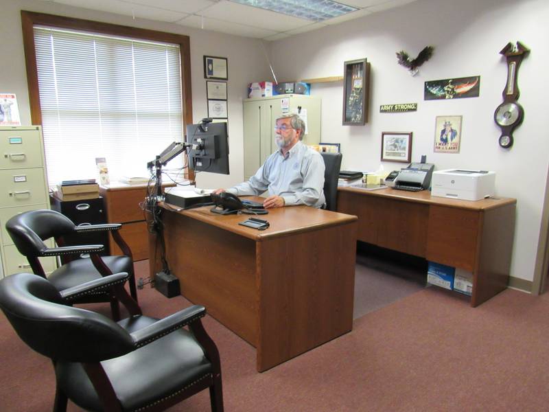 Grundy County Veterans Assistance Commission Superintendent Ken Buck works at his computer.