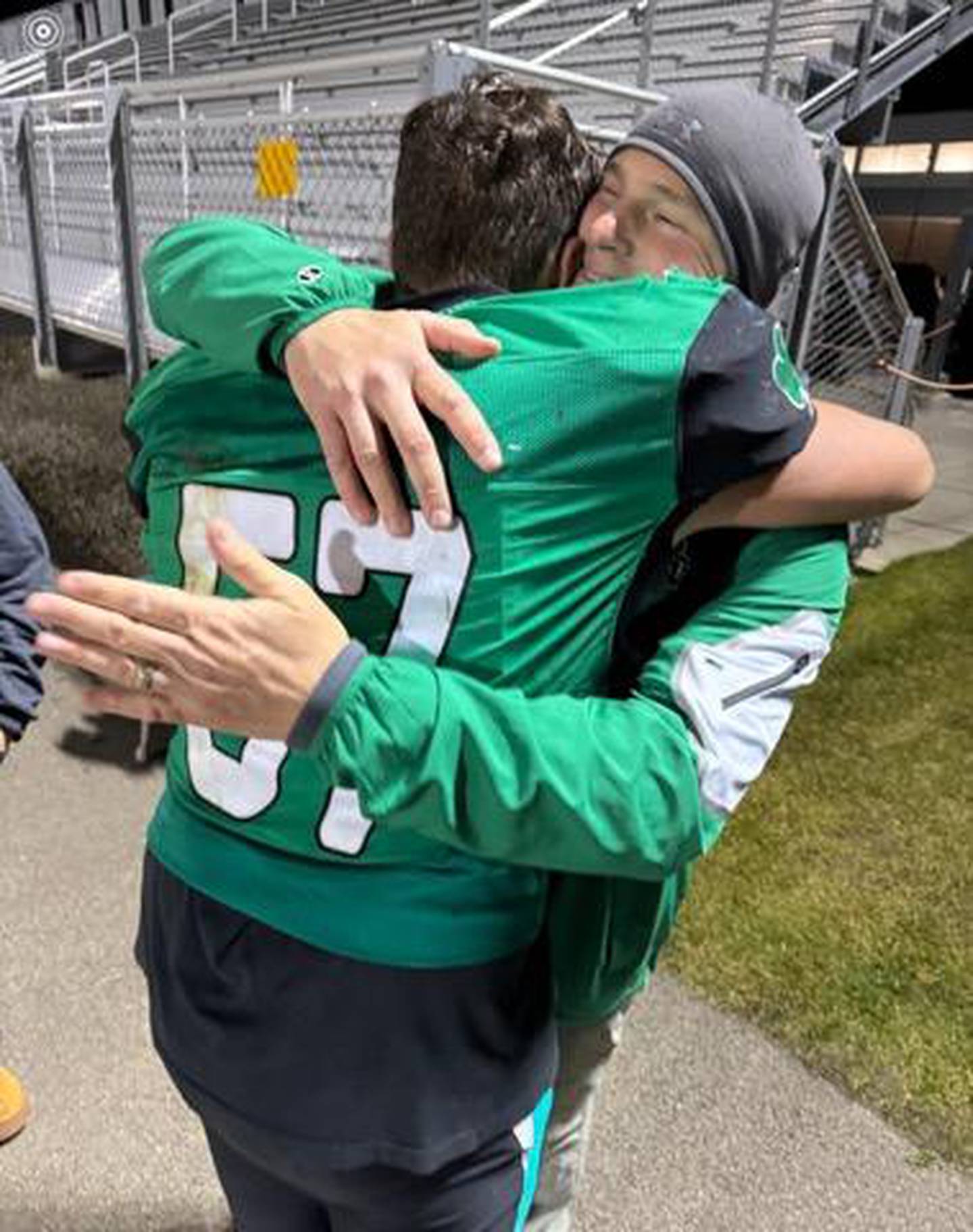 Seneca head football coach Terry Maxwell gives his son, Zebadiah, a hug after a Fighting Irish victory last season.