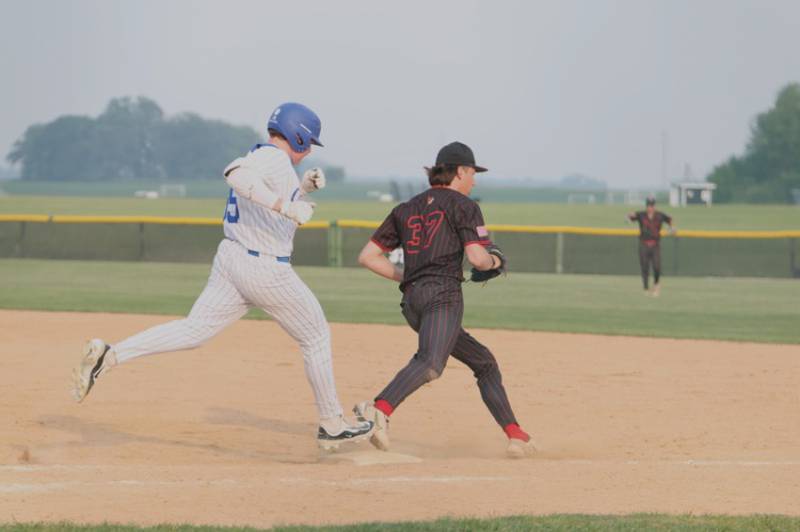 Benet's Jake Rifenburg beats Burlington Central's Liam Schultz to the bag for the out at the Class 3A Kaneland Sectional Semi Final on Thursday, June 5, 2025 in Maple Park.