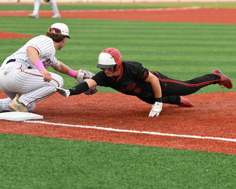 Yorkville's Justin Giese, right, gets checked up at first by Romeoville's Nate Lubinski (14) during the regional game on Thursday May 29, 2025, held at Yorkville High School.