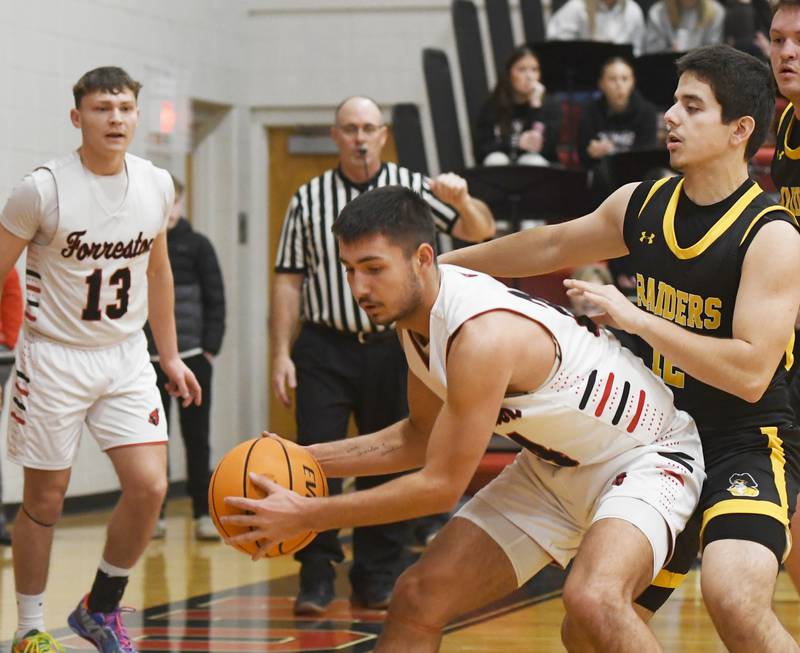 Forreston's Mickey Probst protects the ball against AFC's Naim Mimini on Saturday, Jan. 17, 2026 at Forreston High School.