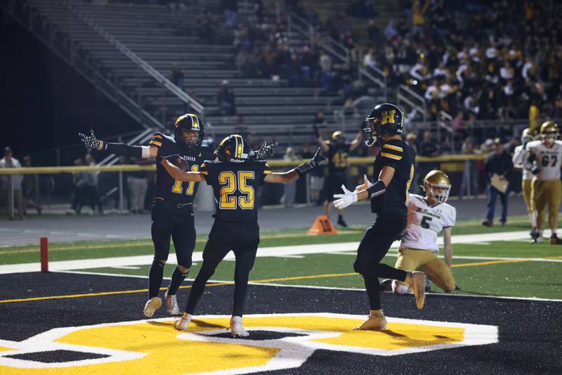 Herscher's Mason Roberts (25) celebrates a touchdown with teammates Reed Laird, left, and Gavin Nelson	during the Tigers 45-28 loss to Bishop McNamara on Friday, Sept. 5, 2025.