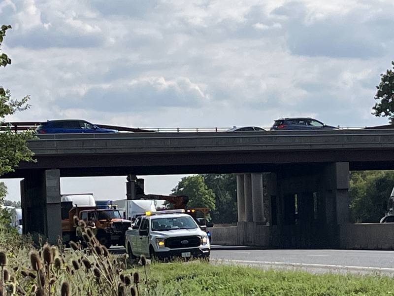 Illinois Department of Transportation crews work under the bridge over Interstate 55 in Joliet on Monday, Aug. 19, 2024.  Debris fell from the bridge Monday afternoon causing lane closures.