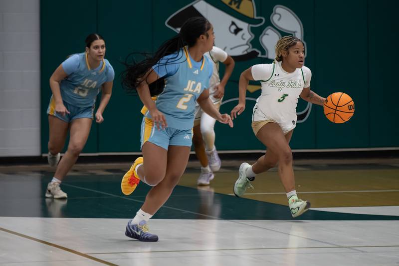 Bishop McNamara's Eliana Isom brings the ball up during Bishop McNamara's game against Joliet Catholic on Wednesday, Feb. 11, 2026.