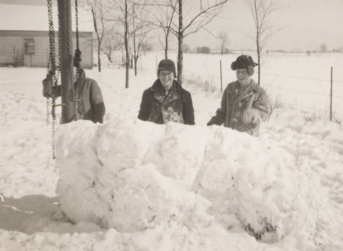 Three students at Church School in rural Oswego with their snow fort in about 1943. (Little White School Museum)