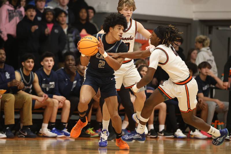 Oswego East’s Jacsen Tucker works the ball against Minooka’s Nehemiah Brown on Friday, Jan. 16, 2026 in Minooka.