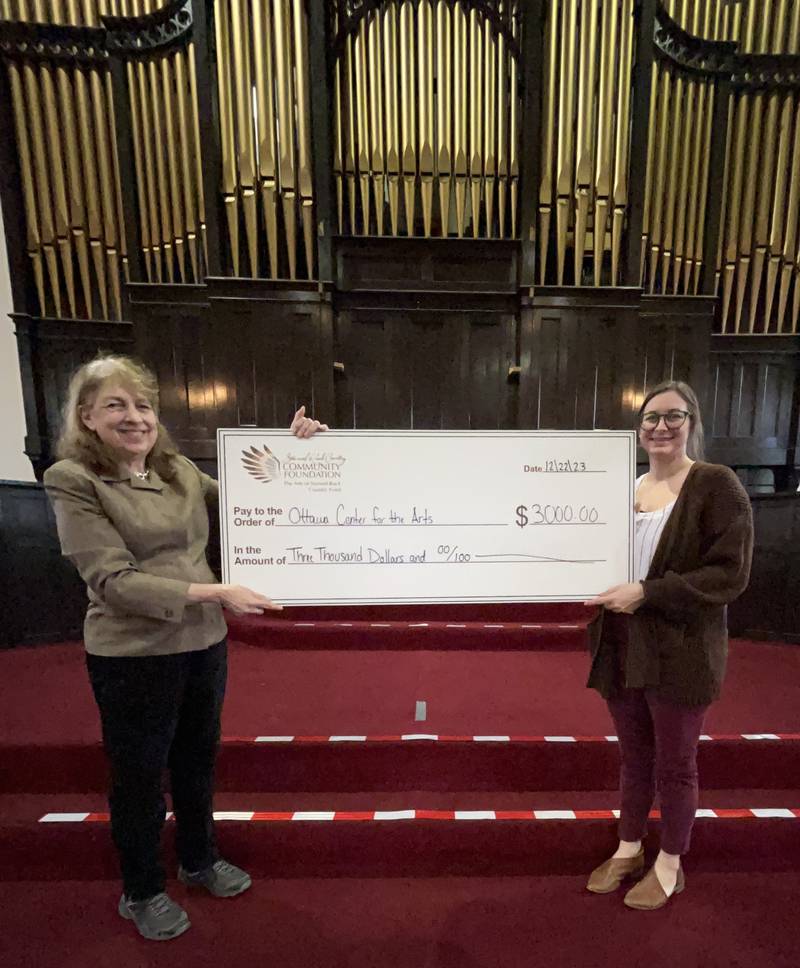 Ottawa Center for the Arts Executive Director Anne Badger (left) with Arts of Starved Rock Country Administrator Amanda Zehr. The center received a $3,000 grant from the Starved Rock Country Community Foundation fund.