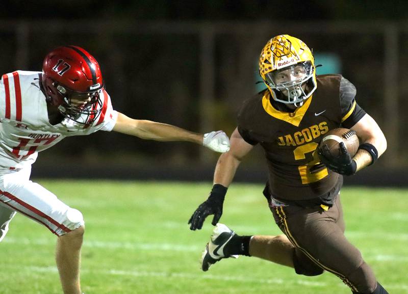 Jacobs’ Caden DuMelle turns a corner and escapes past Huntley’s Jacob Marx in varsity football at Jacobs High School in Algonquin on Friday, Sept. 26, 2025.
