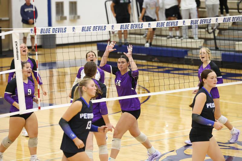 Manteno's Maddie Gesky, center, celebrates a point with teammates during the Panthers' victory in three sets, 19-25, 25-19, 25-21, over Peotone on Tuesday, Sept. 23, 2025.