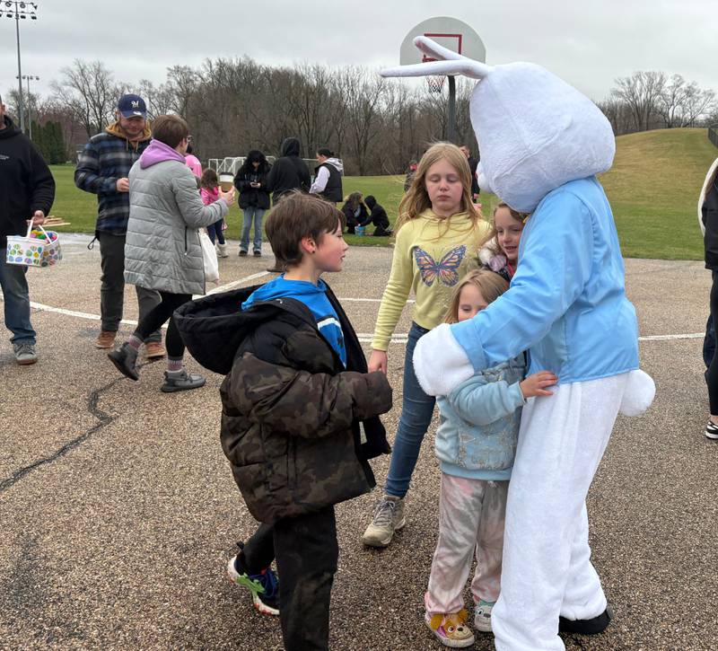 The Easter Bunny visits with Grayson White, left, 7, Natalie Andrus, 10, Elaina Andrus, 8, and Olivia White, 5, of Johnsburg after the Easter Egg Hunt at Sunnyside Memorial Park in Johnsburg, Saturday, April 4, 2026.