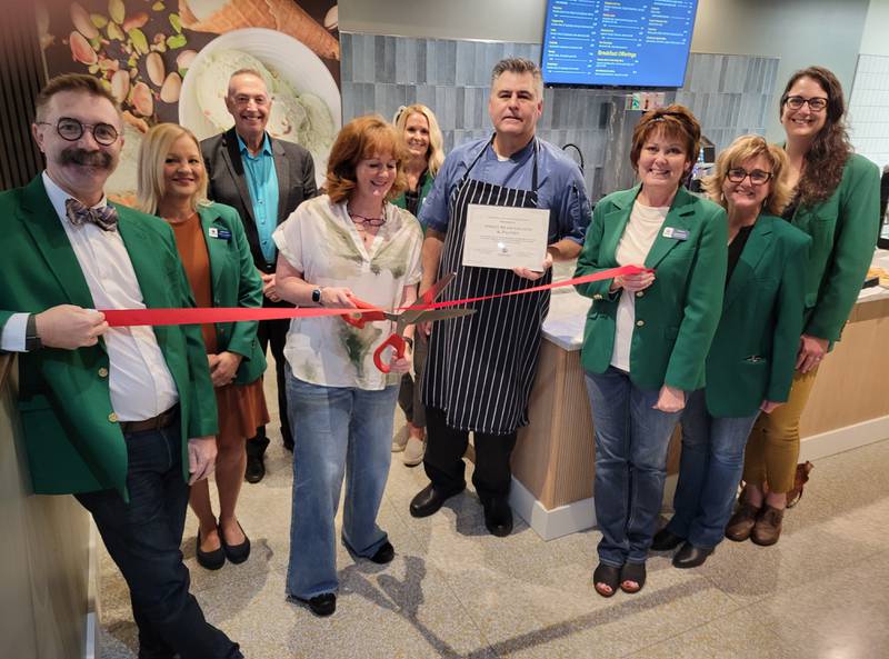 Maura (with scissors) and John Mathias, with City of Ottawa officials looking on Friday morning, cut the ribbon on their new business, the Sweet Bean Gelato and Intelligentsia Coffee Shop, located at 704 La Salle Street in Ottawa.