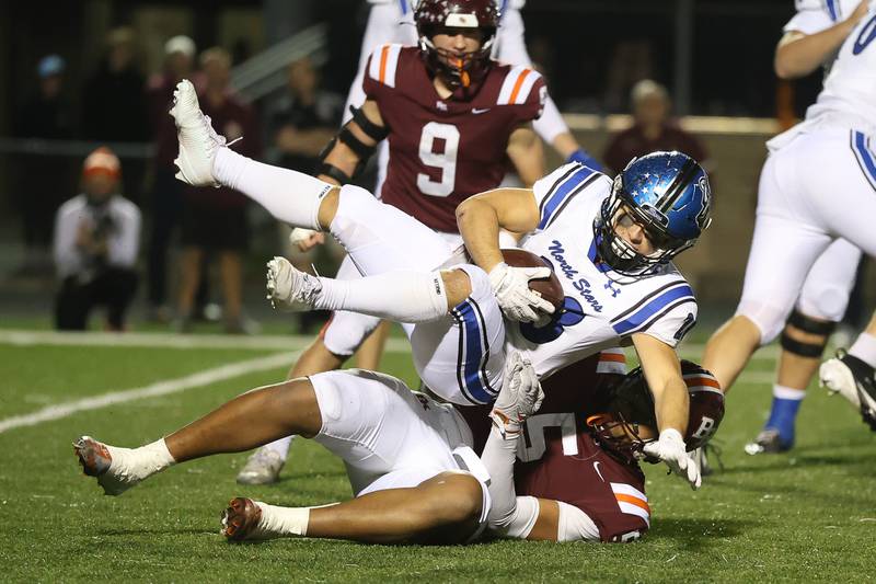 St. Charles North's Carsen Durante is pulled down on a run against Brother Rice in the third round of the playoffs on Saturday, Nov. 15, 2025 in Chicago.