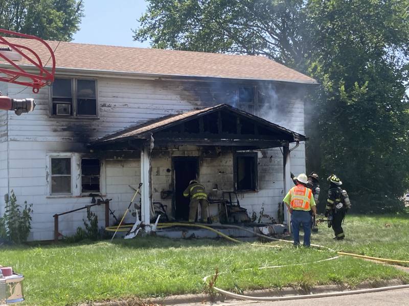 Fire fighters inspect the results of a residential fire on the 200 block of West Clark St. in Princeton Friday afternoon.