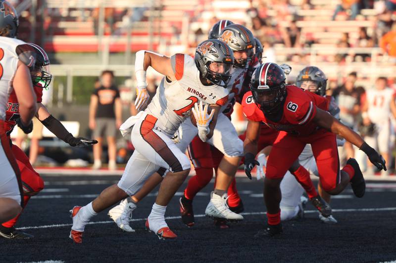 Minooka’s Joseph Partridge runs up the middle against Bolingbrook. Friday, Aug. 26, 2022, in Bolingbrook.