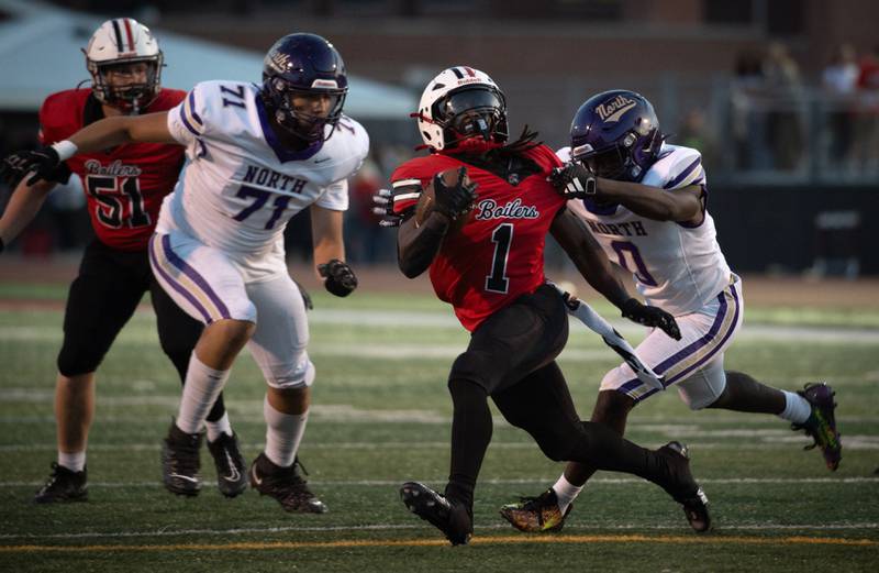 Bradley-Bourbonnais' Kyren Edmon carries the ball on a play as T.F. North's Derrick Sparkman, right, attempts to tackle in a game on Friday, August 29, 2025.