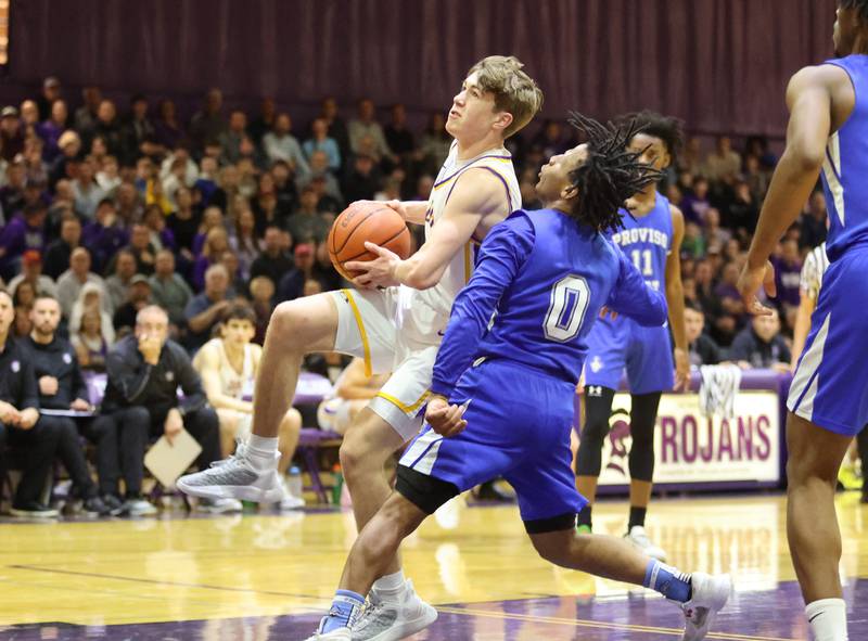 DGN's Maxwell Haack (14) drives to the basket during the boys 4A varsity regional final between Downers Grove North and Proviso East in Downers Groves on Friday, Feb. 24, 2023.