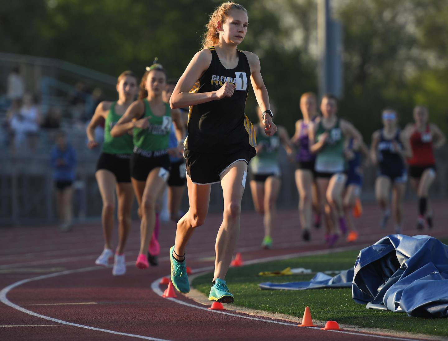 Glenbard North’s Grace Schager leads all competitors to a win in the 3,200-meter run in the Class 3A Rolling Meadows girls tracking field sectional meet on Wednesday, May 10, 2023.