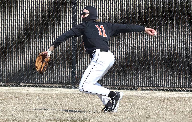 DeKalb’s Landon Simonson gets the ball back into the infield after fielding a base hit during their game against Dixon Tuesday, March 28, 2023, at DeKalb High School.
