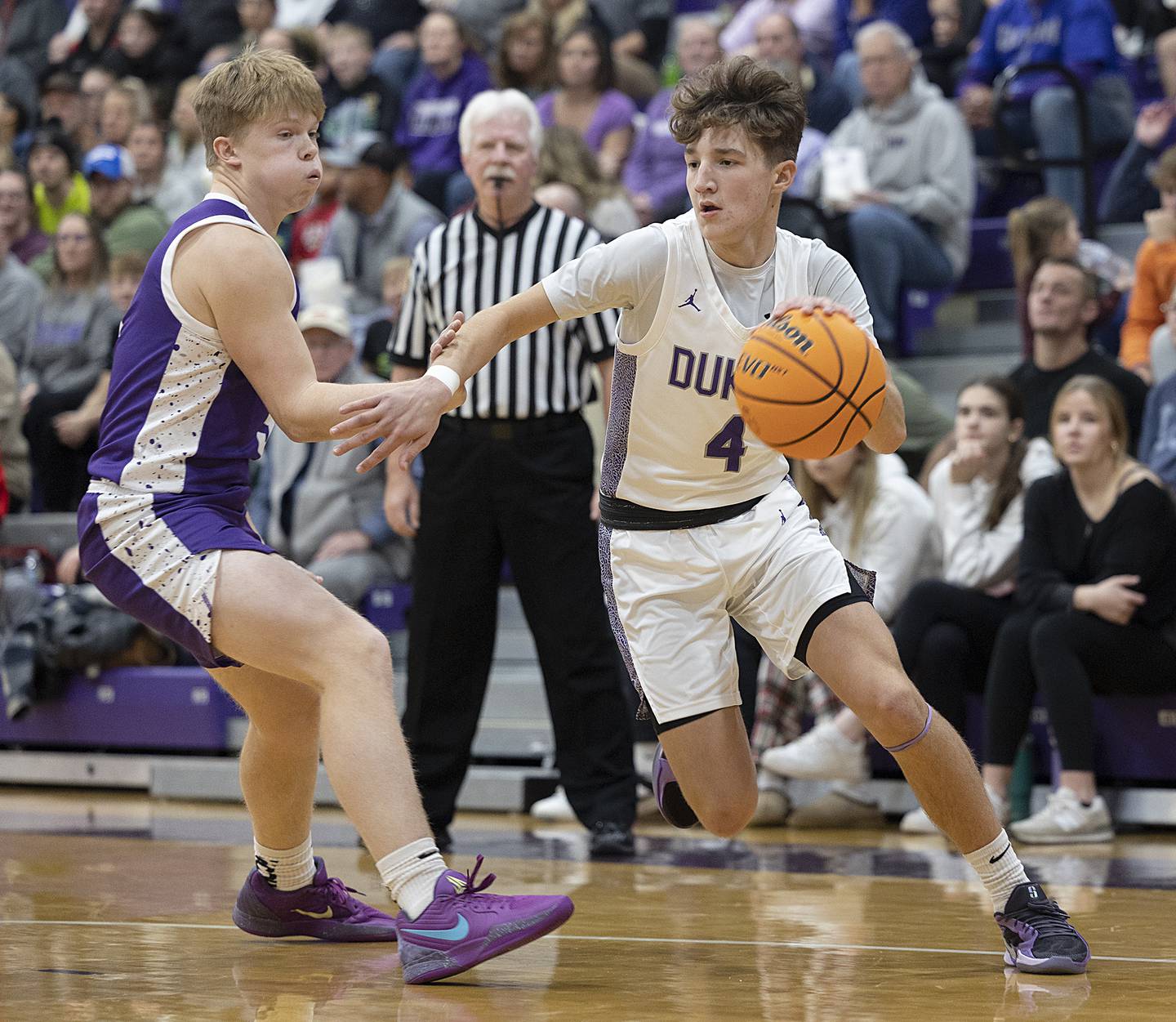 Dixon’s Brody Nicklaus drives to the hoop against Rochelle’s Carson Lewis Monday, Dec. 9, 2024, at Dixon High School.