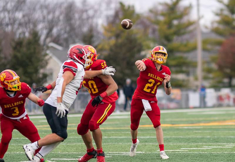Batavia’s Ryan Boe (21) throw a touchdown pass against Yorkville during a 7A quarterfinal playoff football game at Batavia High School on Saturday, Nov 12, 2022.