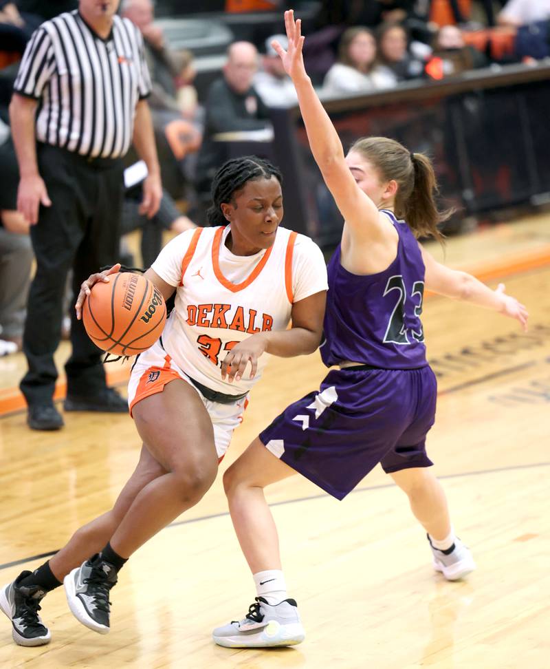 DeKalb's Cayla Evans drives past Rochelle's Alivia Henkel during their game Monday, Nov. 28, 2022, at DeKalb High School.
